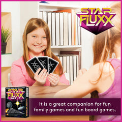 Looney Labs Star Fluxx illustrated playing cards on table