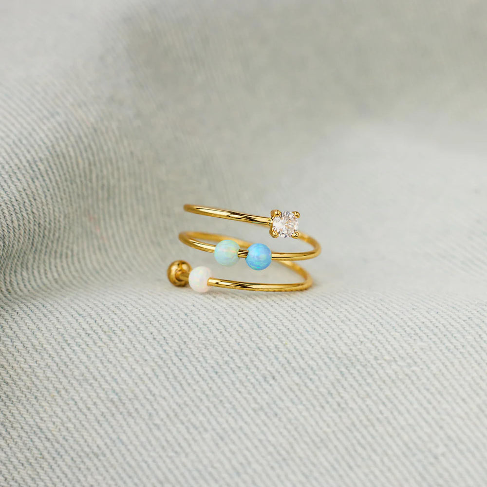 Close-up of adjustable open ring showing opal beads for calm concentration.