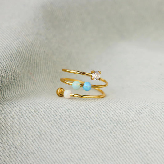 Close-up of adjustable open ring showing opal beads for calm concentration.
