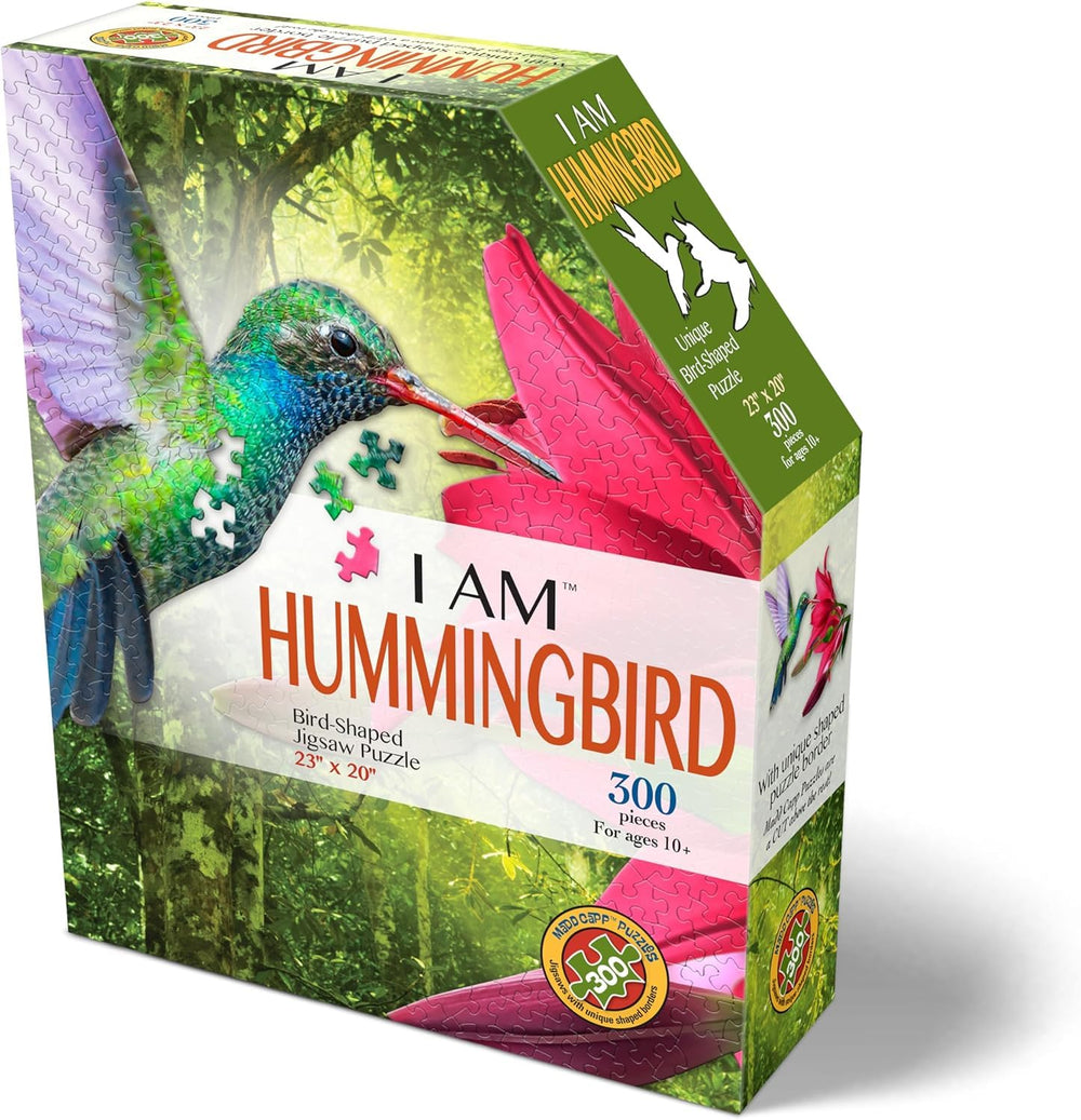 Madd Capp I Am Hummingbird puzzle cover art with pink lilies, ideal for display.