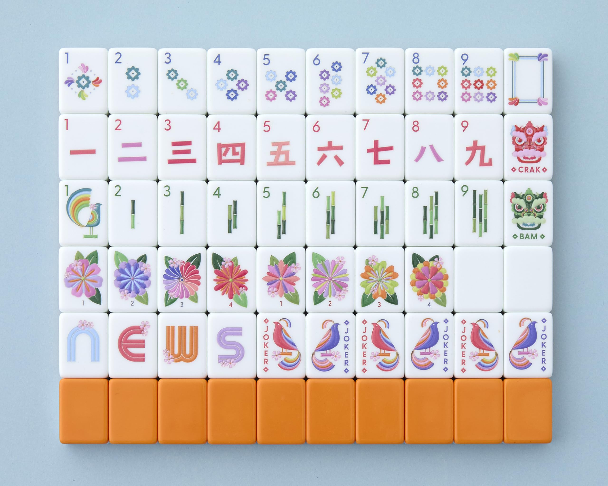 Paradise tiles by Mahjong Co. in front view show cosmic orange back and crisp artistry.