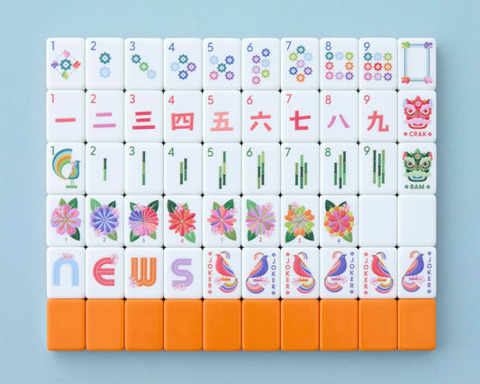 Paradise tiles by Mahjong Co. in front view show cosmic orange back and crisp artistry.