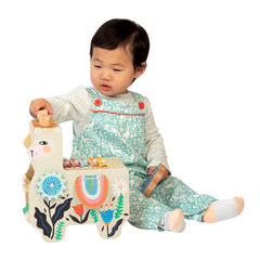 Manhattan Toy Musical Lili Llama clacking saddlebags drum feature invites hands-on play