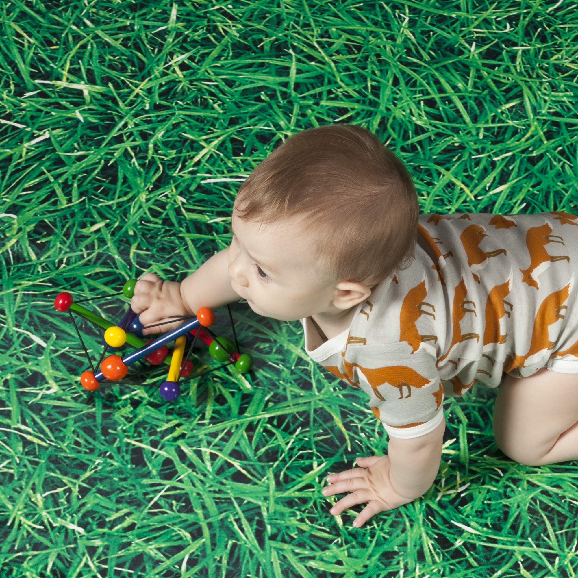 Manhattan Toy Skwish Classic 6 inch elastic ties allow flattening and rebound, aiding hand coordination.