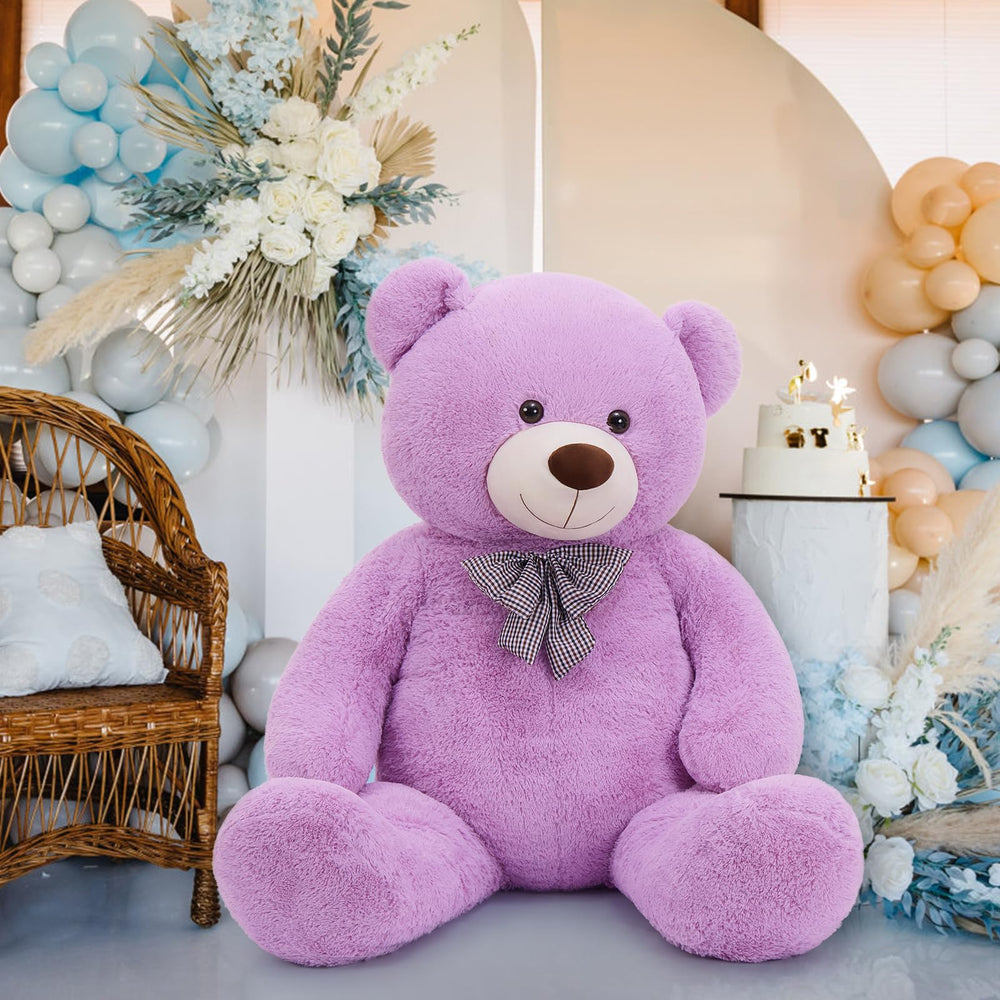 MaoGoLan 55-inch teddy bear resting in a cozy bedroom for snuggle time.