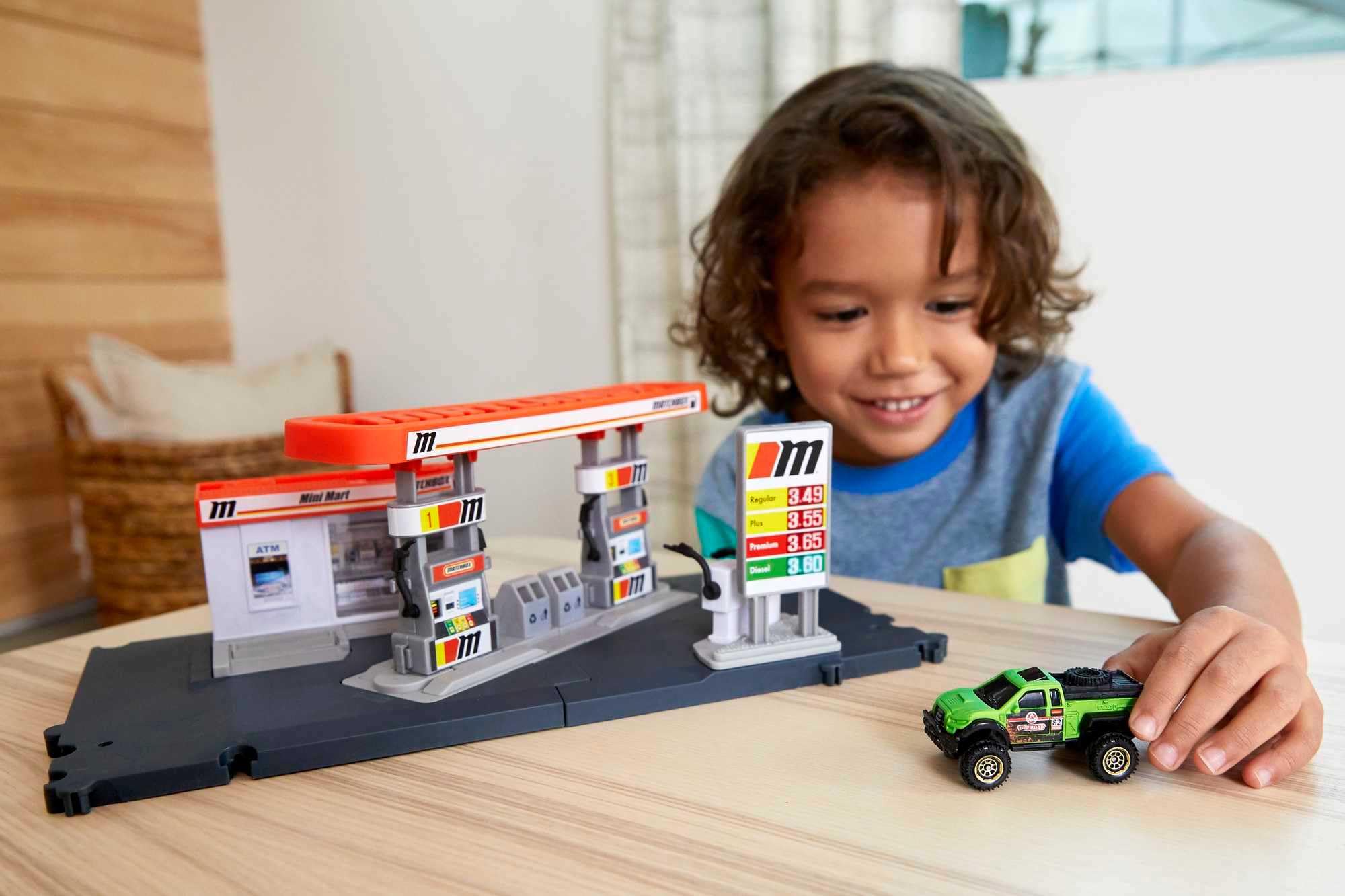 Matchbox fuel station doors open when a car arrives, encouraging storytelling.