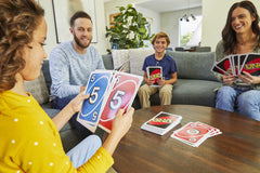 Mattel Games Giant UNO with color-blind symbols on cards for inclusive play.