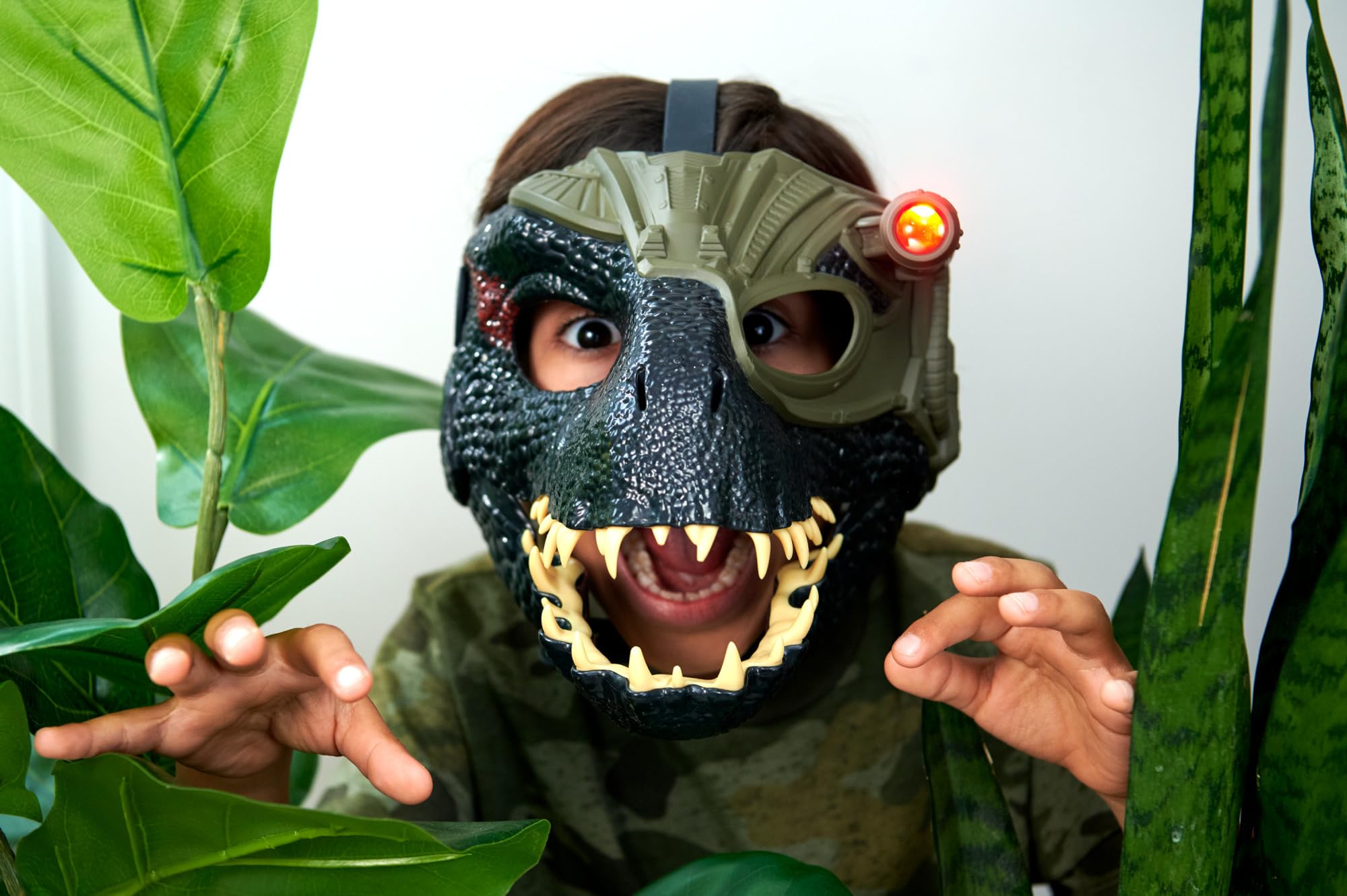 Mattel Indoraptor mask showing red tracker light at left temple for chase play
