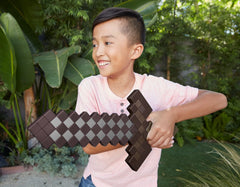 Mattel Minecraft Deluxe Netherite Sword in-action highlights immersive pretend combat sounds.