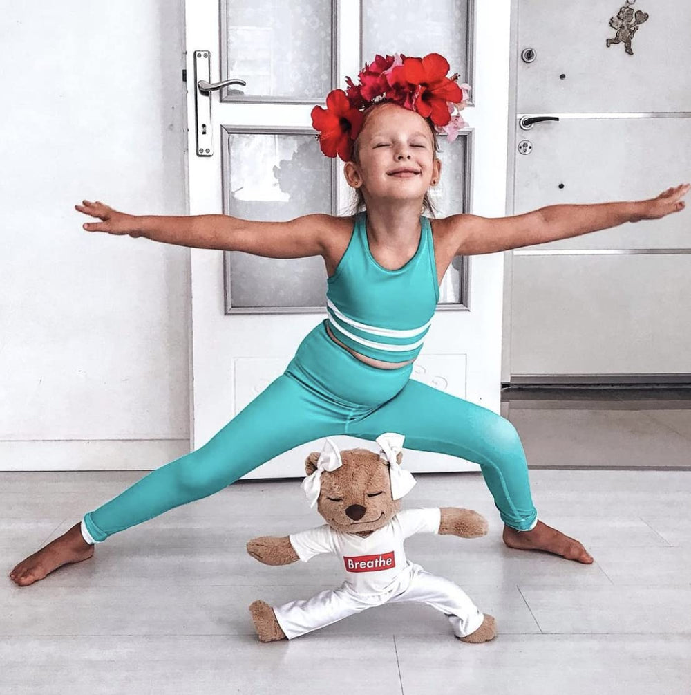 Meddy Teddy teaches kids yoga, guiding little bodies through playful poses.