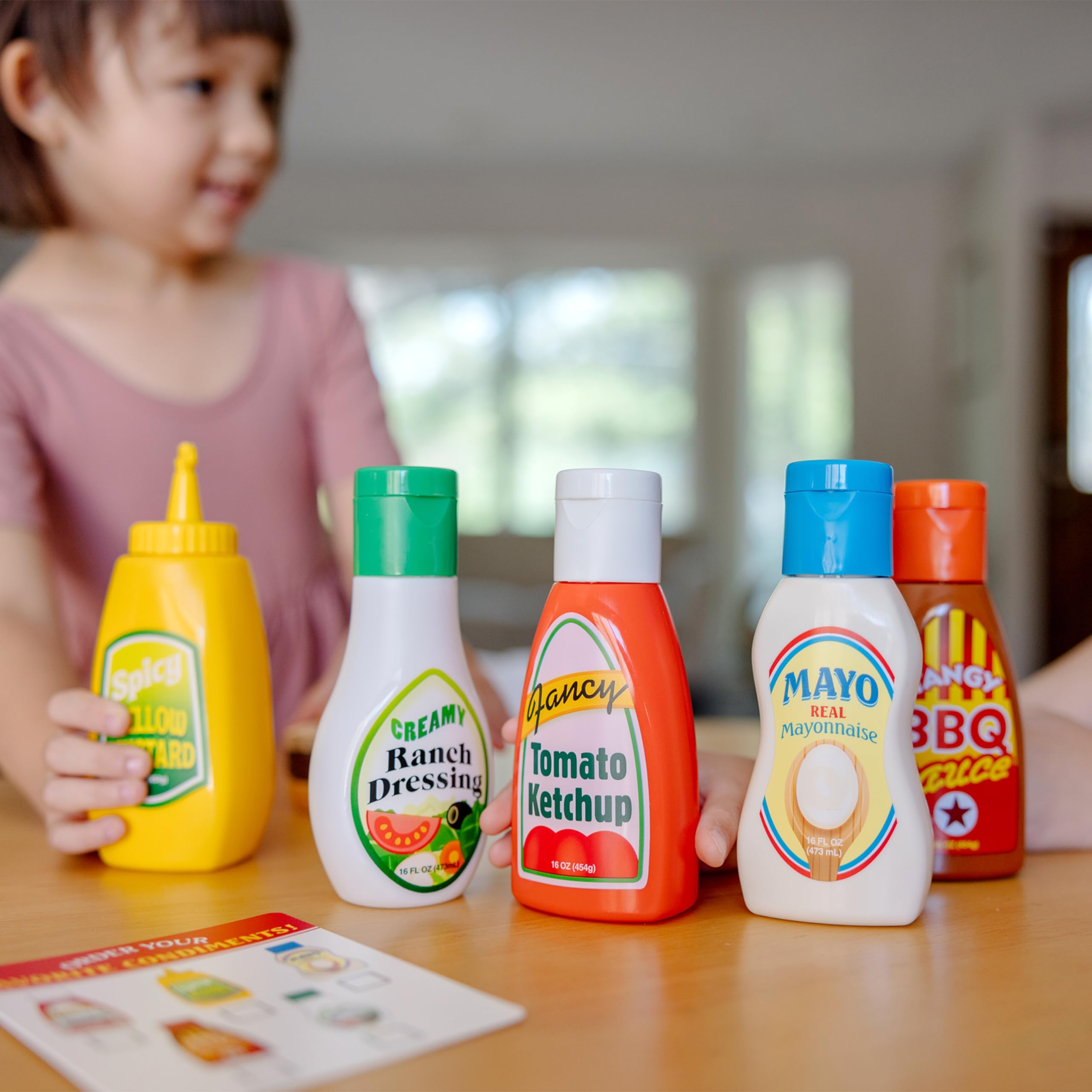 Melissa & Doug barbecue sauce bottle for realistic pretend barbecue play.