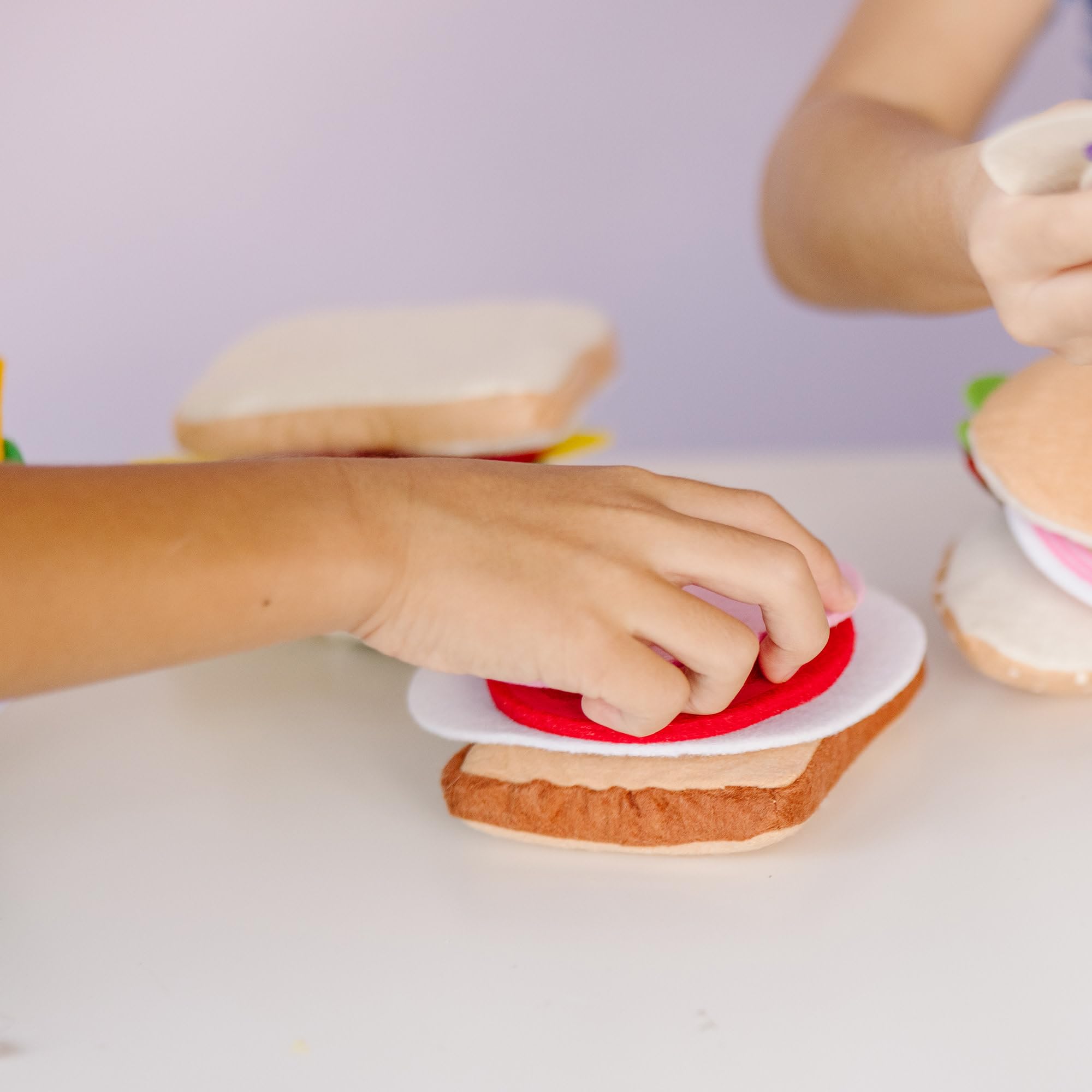 Melissa and Doug felt sandwich grinder hoagie section demonstrates layering and imagination.