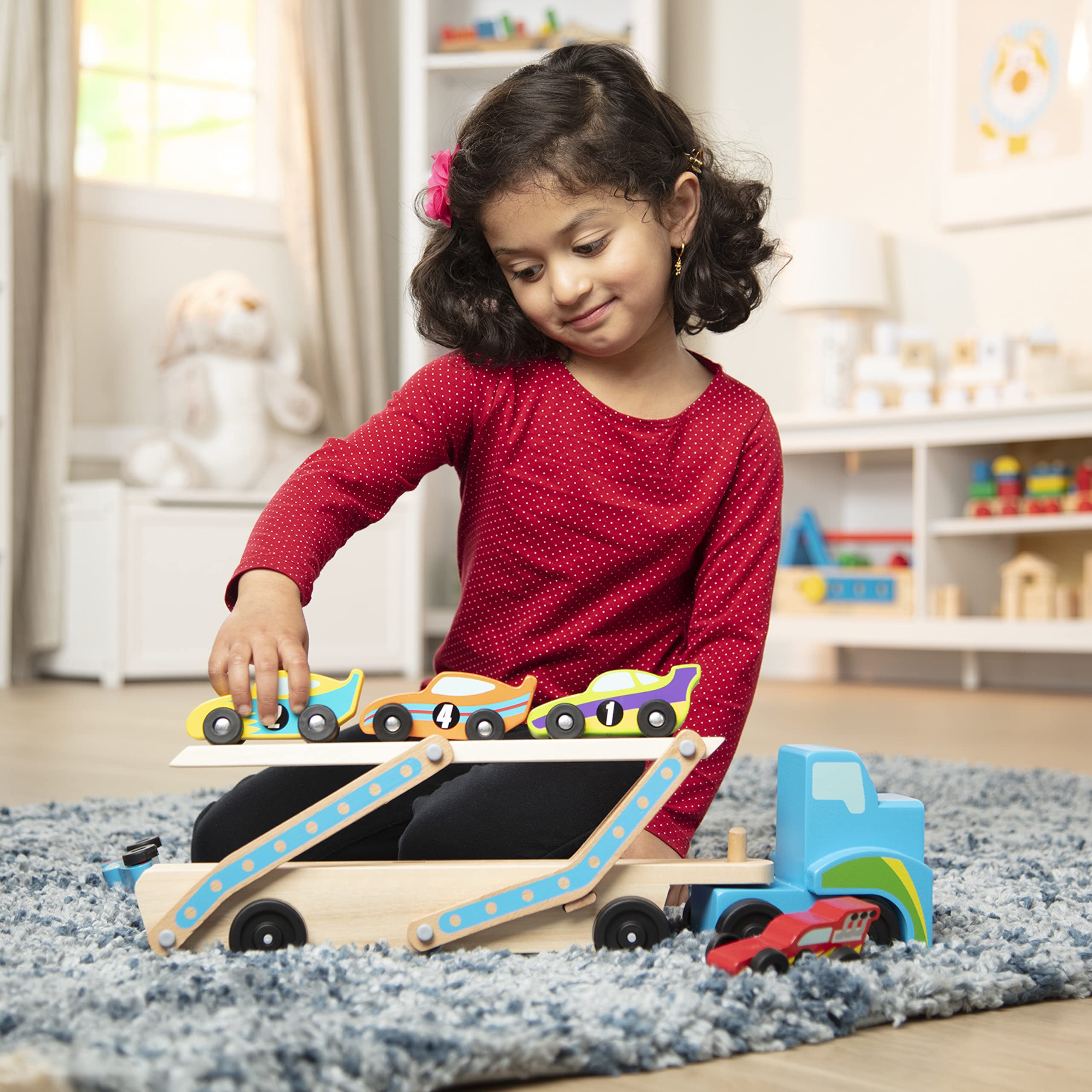 Melissa & Doug Mega Race-Car Carrier features colorful designs that invite sorting by color and pattern.