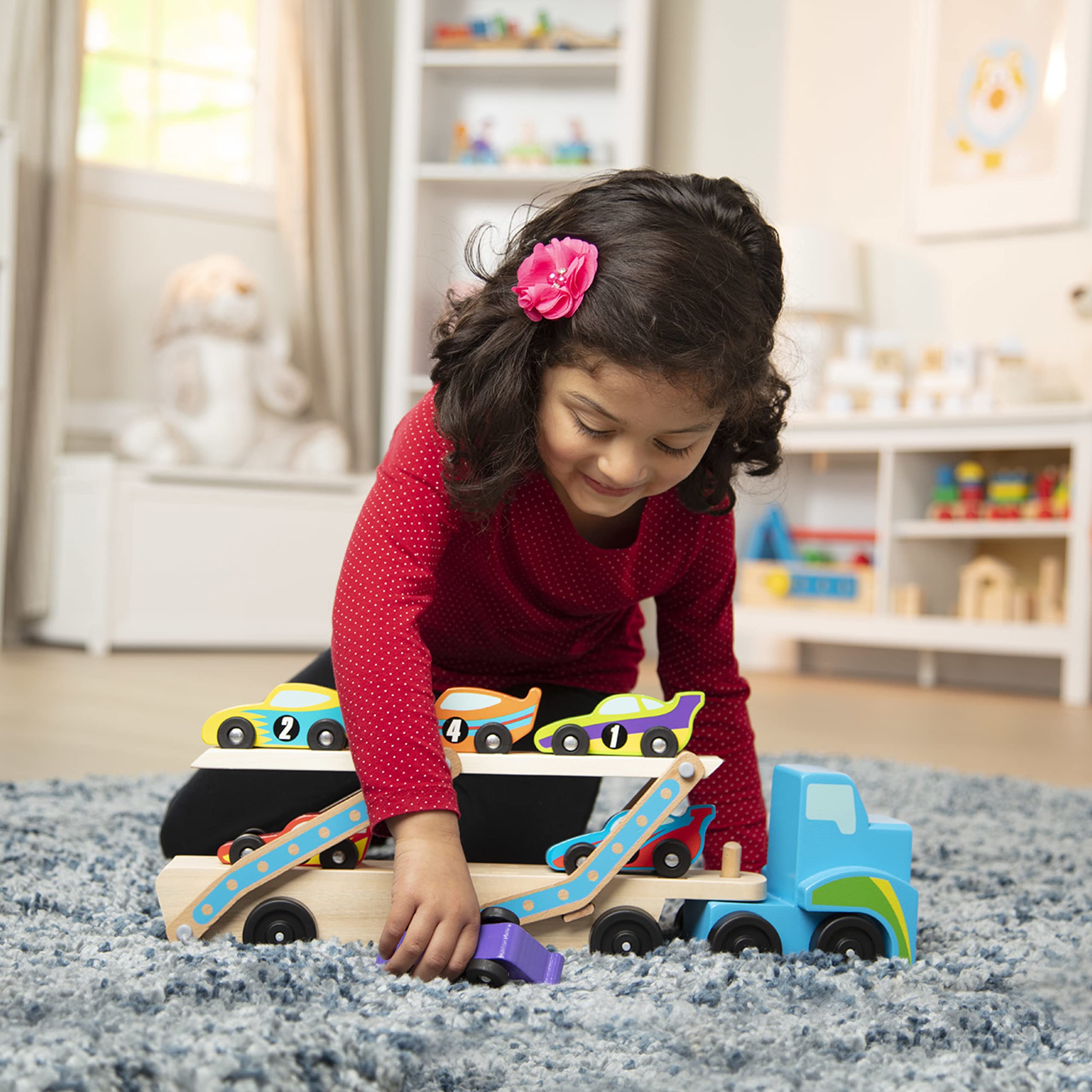 Melissa & Doug Mega Race-Car Carrier trailer with cars highlights double-decker design for exciting play.