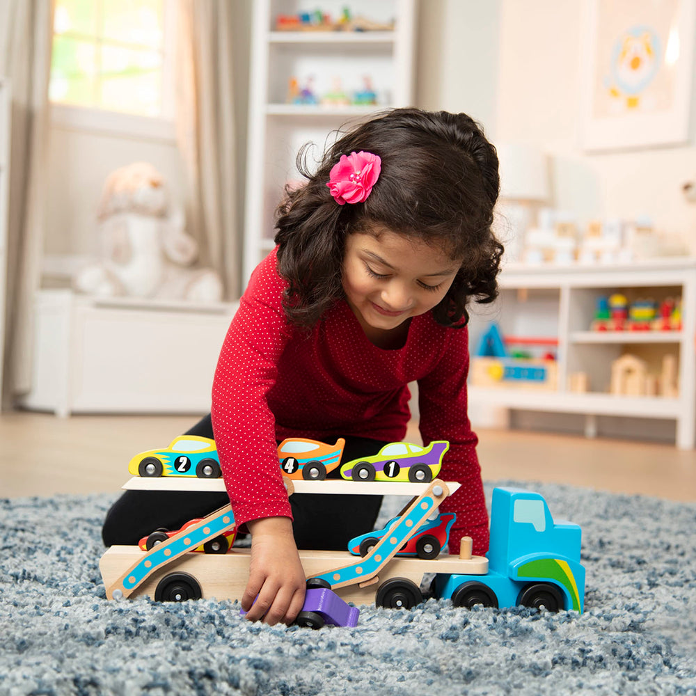Melissa & Doug Mega Race-Car Carrier trailer with cars highlights double-decker design for exciting play.