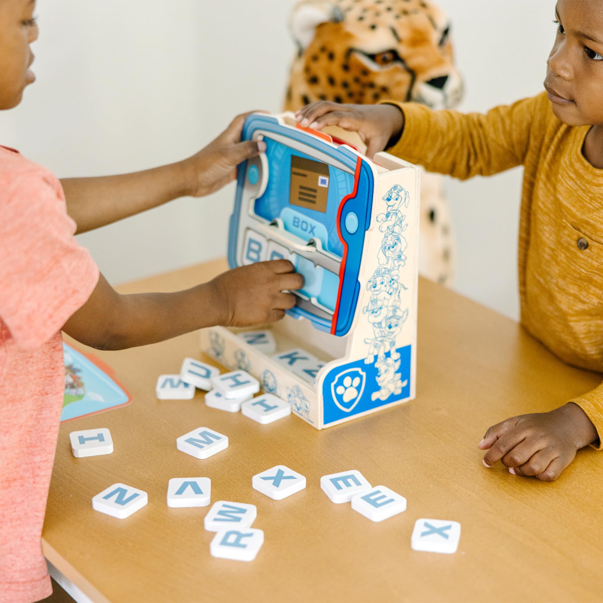 Child enjoys hands-on spelling with PAW Patrol characters.