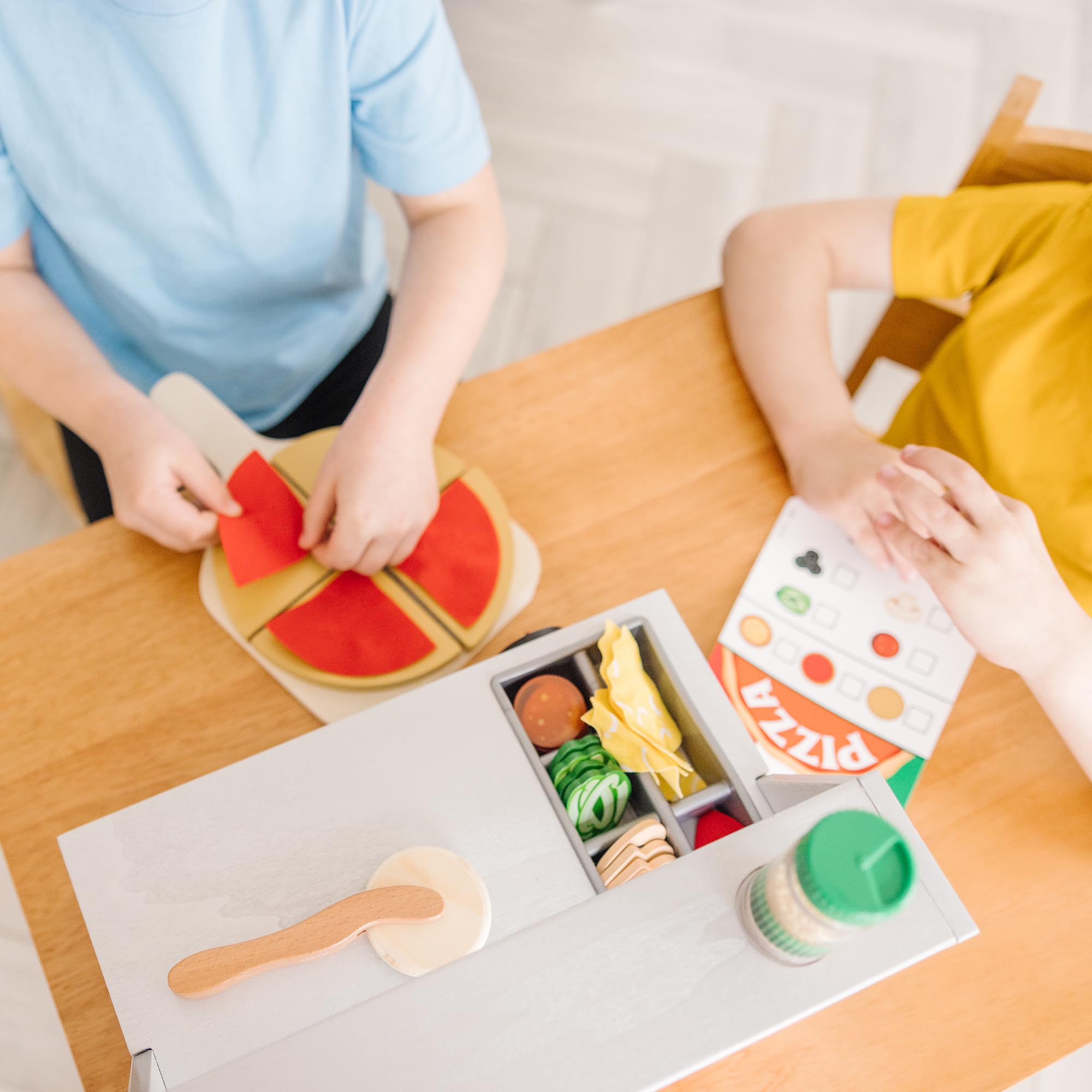 Pizza box and reusable menu from Melissa & Doug for interactive dining scenarios