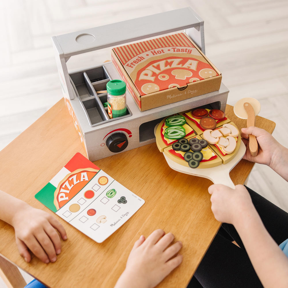 Wooden paddle and rolling cutter add authentic pizza prep play with Melissa & Doug