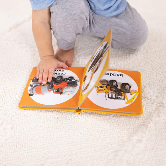 Melissa & Doug Poke-a-Dot Construction Vehicles dump truck image with popping dots for fine motor skills.