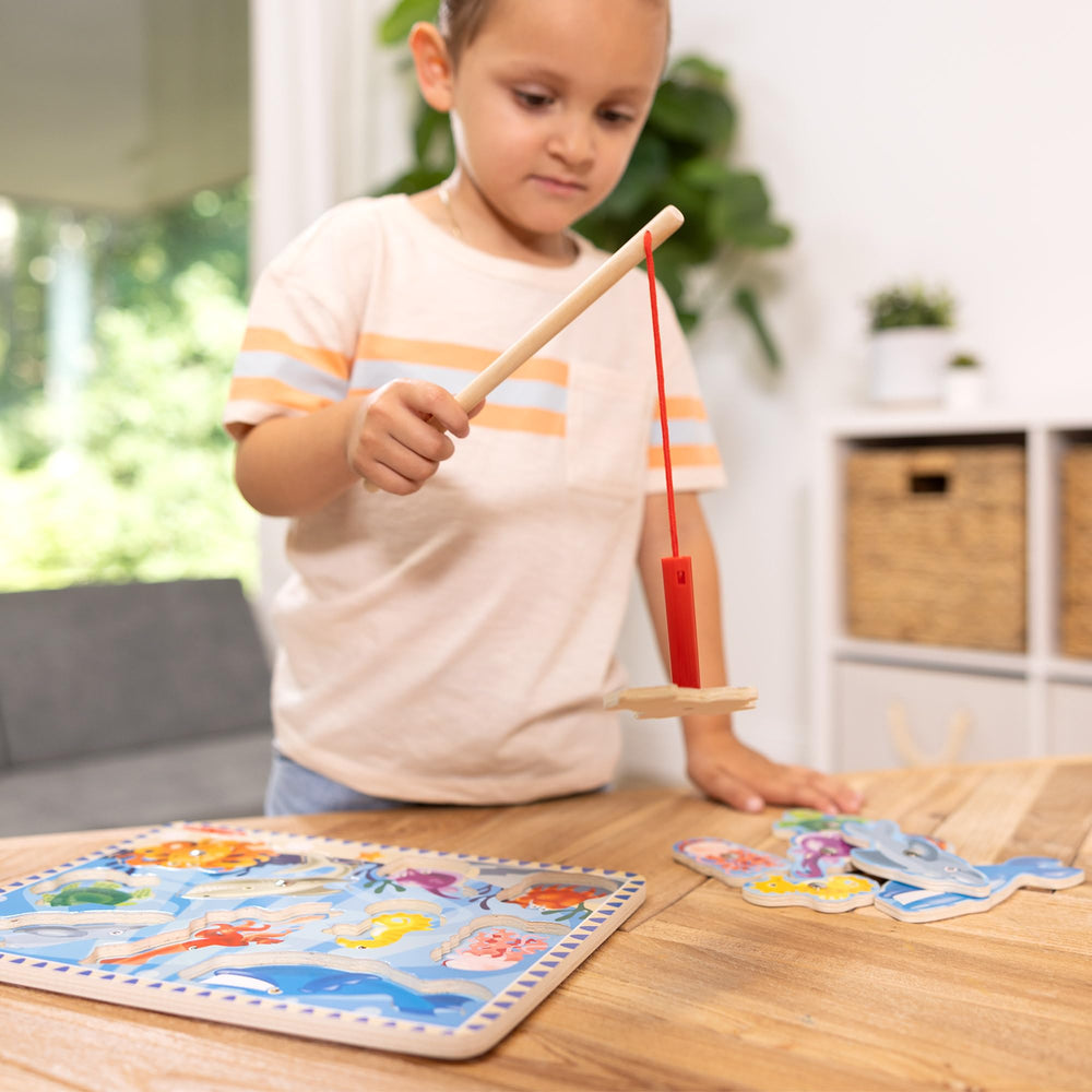 Puzzle board with fish pieces ready for magnetic fishing and exploration.