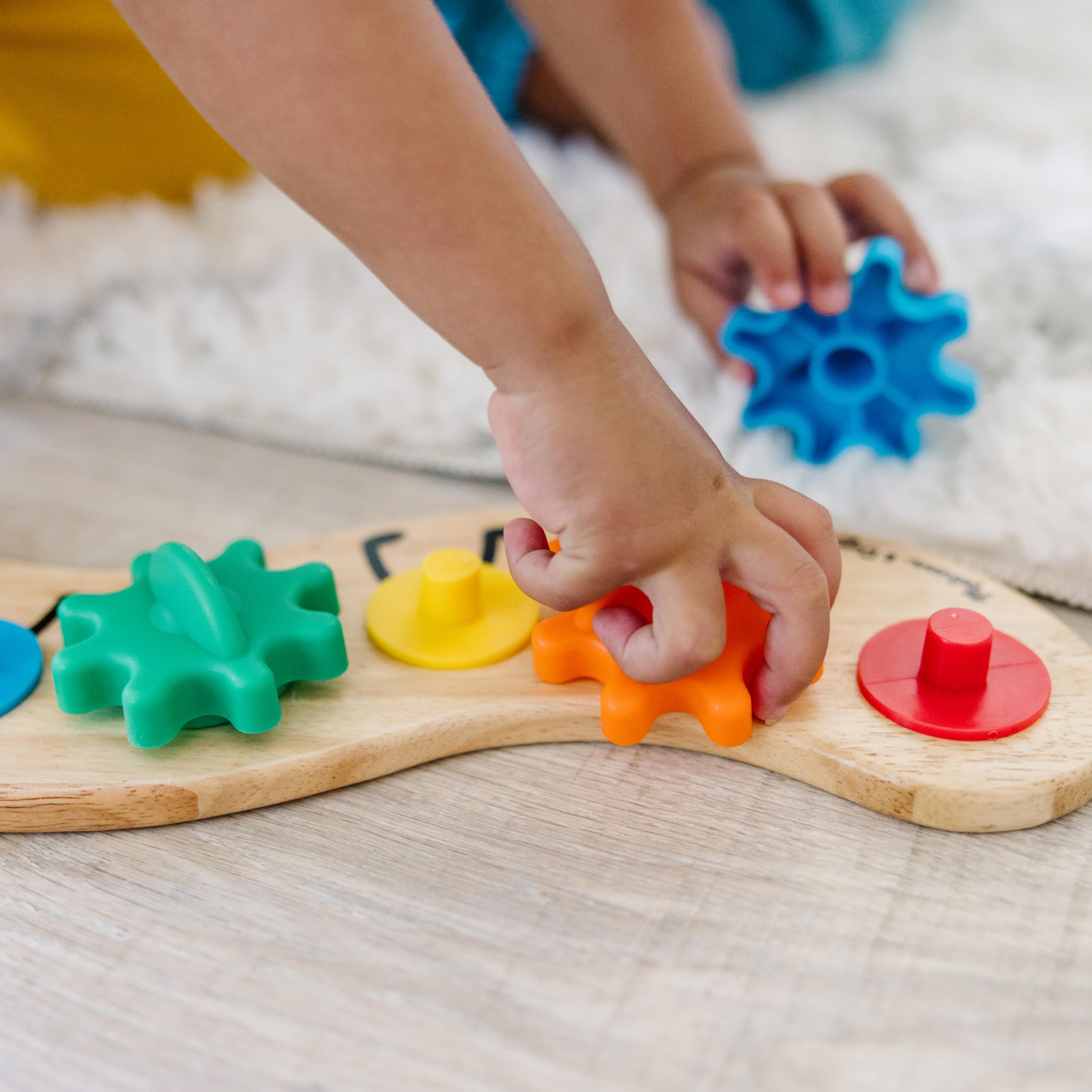 Melissa & Doug Rainbow Caterpillar Gear Toy highlighting painted caterpillar feet on the board.