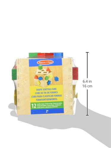 Wooden Melissa & Doug cube with holes matching the shapes.