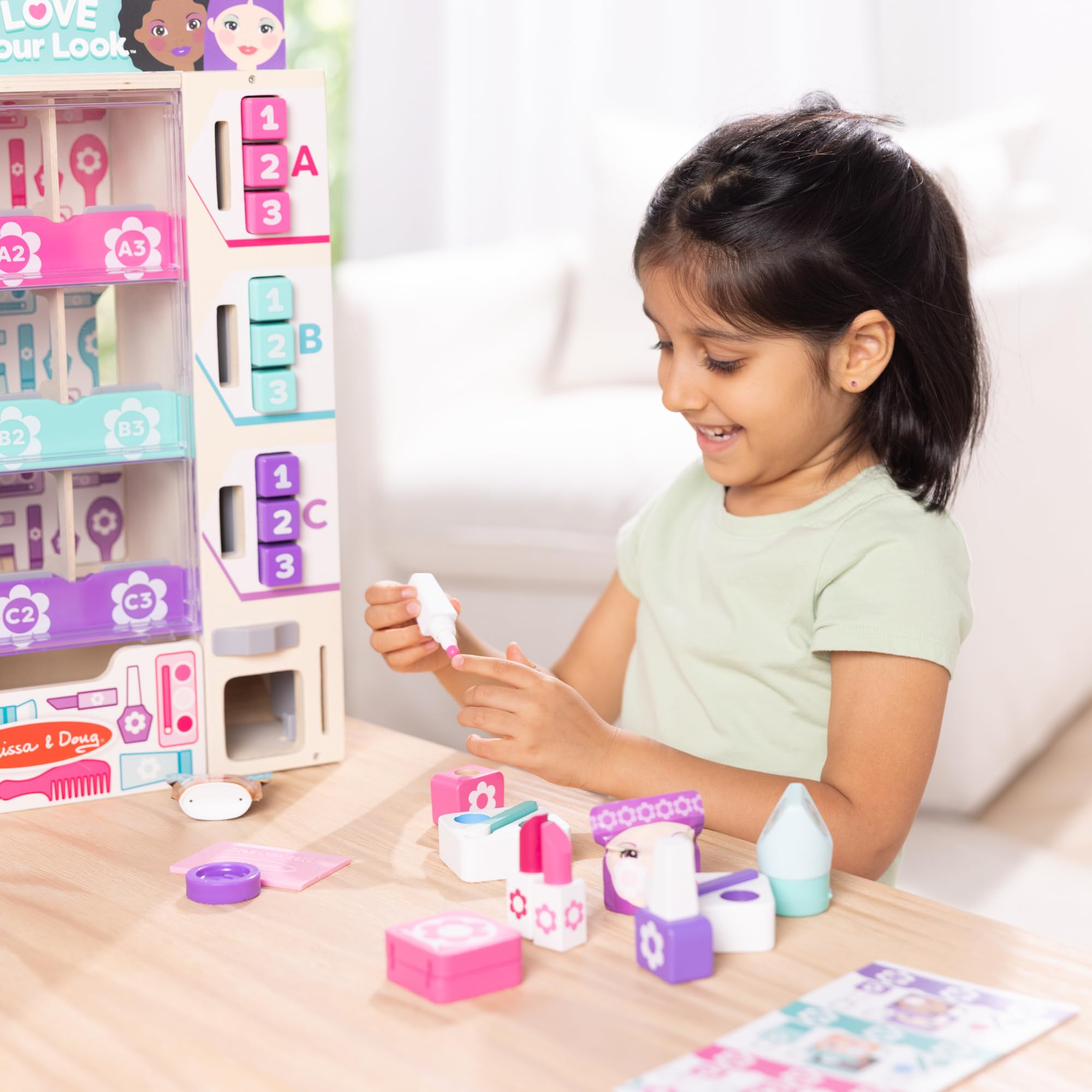 Melissa & Doug kiosk beside child hands illustrating size and kid-friendly scale benefit