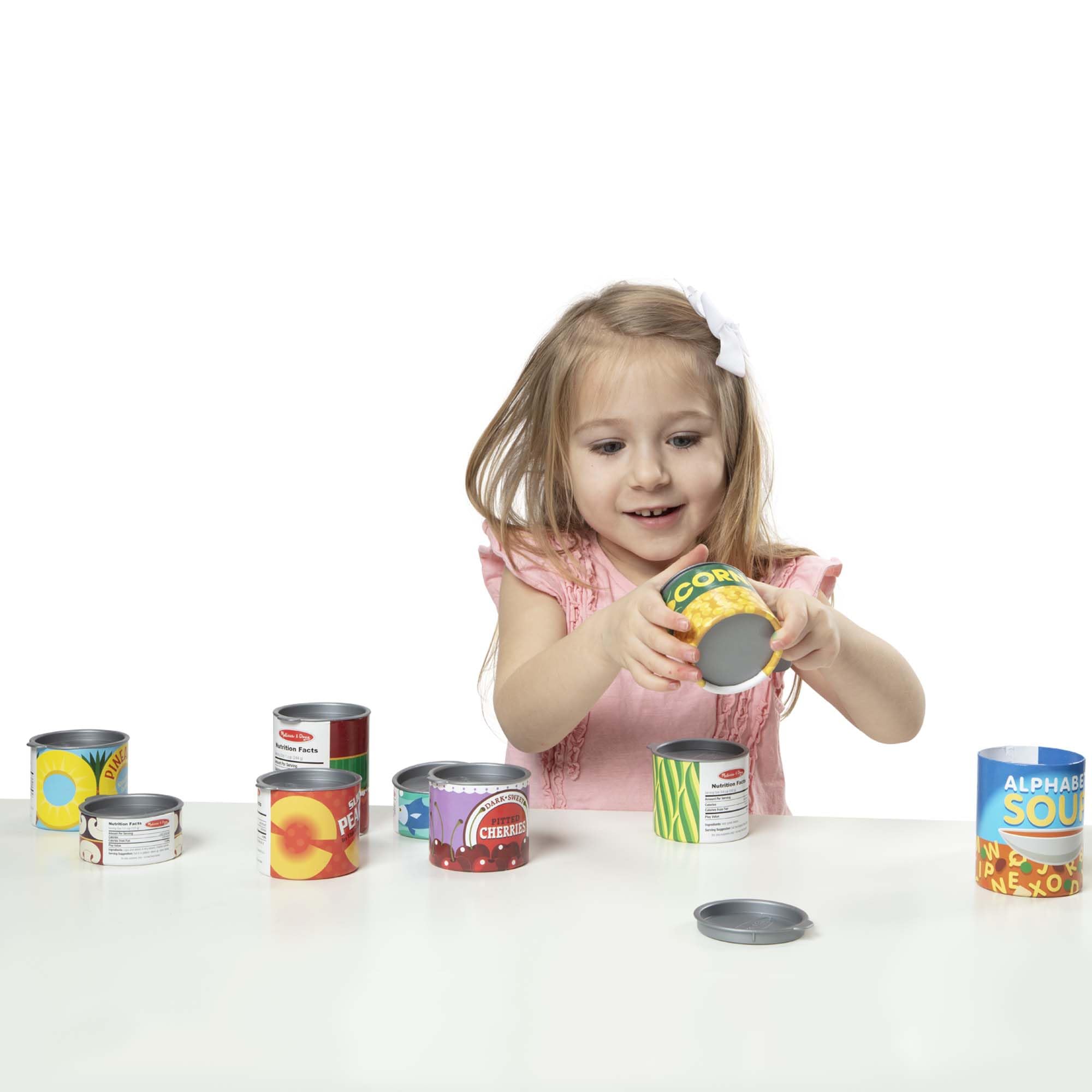 Melissa & Doug cans beside a toy knife to show size scale and safe play dimensions