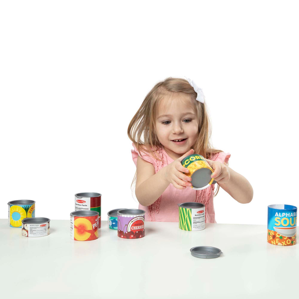 Melissa & Doug cans beside a toy knife to show size scale and safe play dimensions