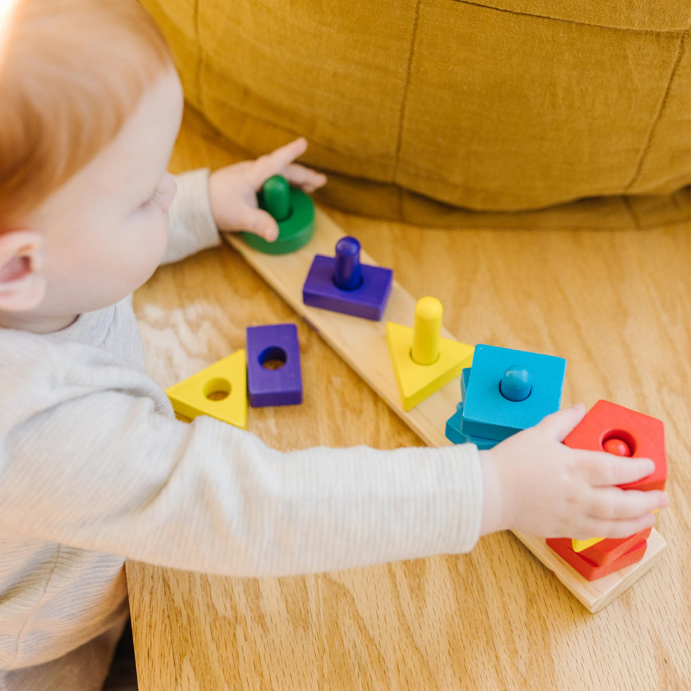 Colorful wooden pieces on Melissa & Doug board for matching activities