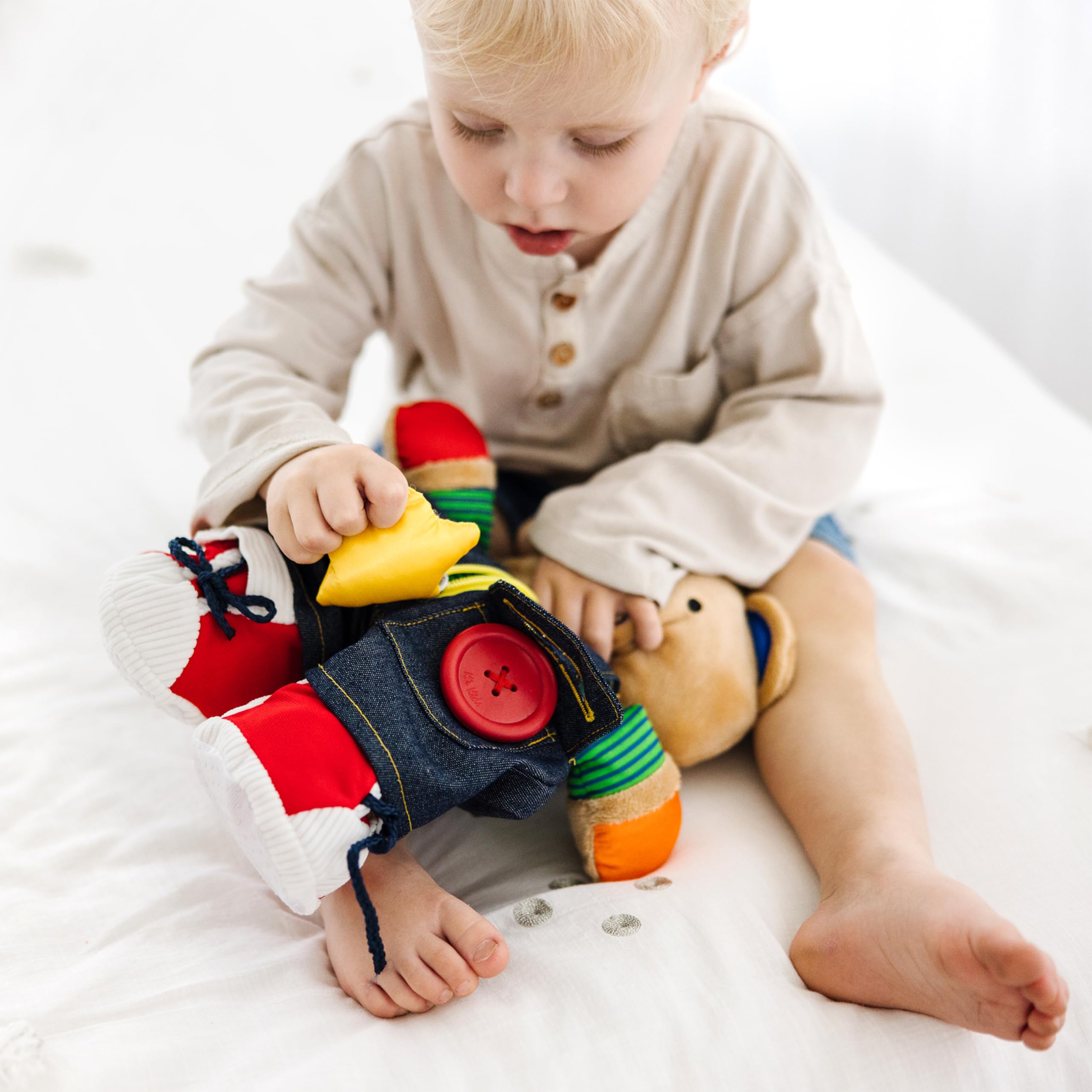 Melissa & Doug Teddy Wear bear multi-texture plush supports sensory development during play.