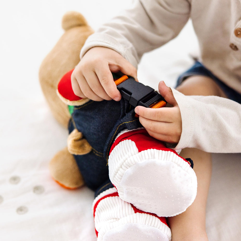 Melissa & Doug Teddy Wear bear removable overalls invite pretend dress-up and problem solving.