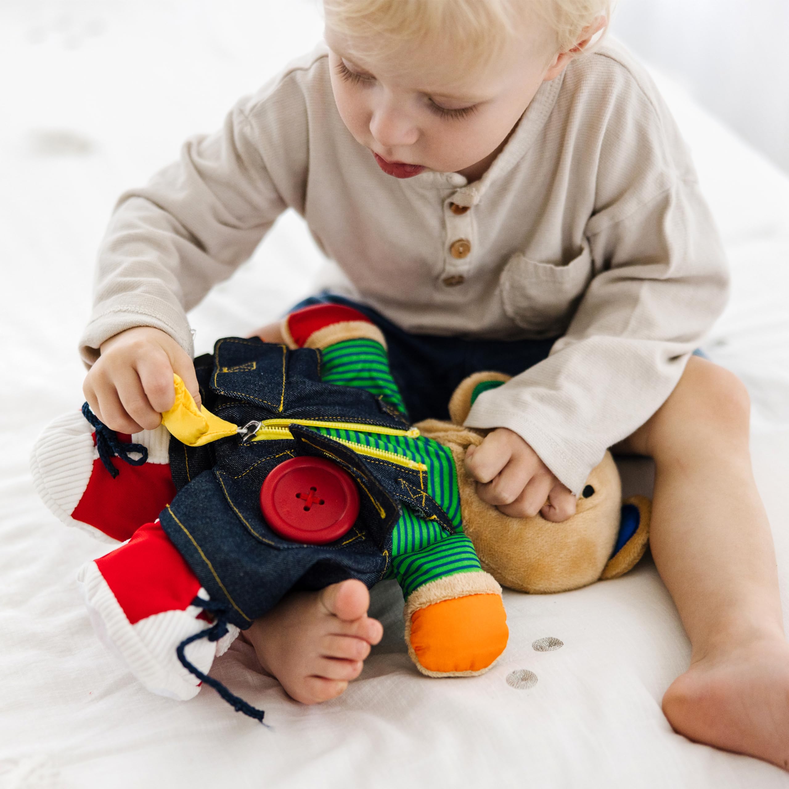 Melissa & Doug Teddy Wear bear featuring zipper closure supports hand-eye coordination development.