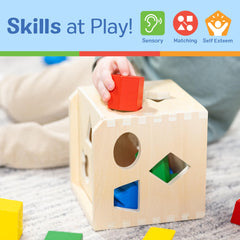Toddlers grasping a chunky Melissa & Doug shape piece for fine motor work.