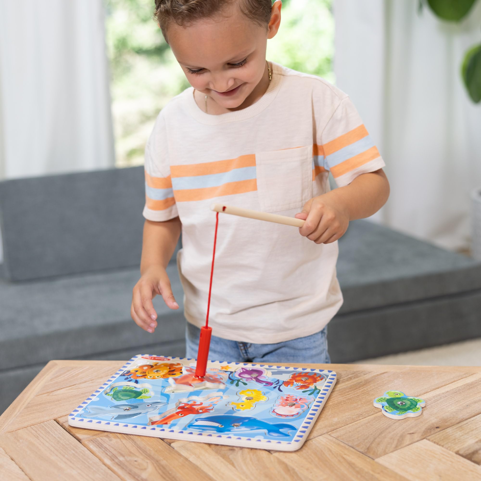 Wooden fishing board with magnets from Melissa & Doug for fine motor practice.