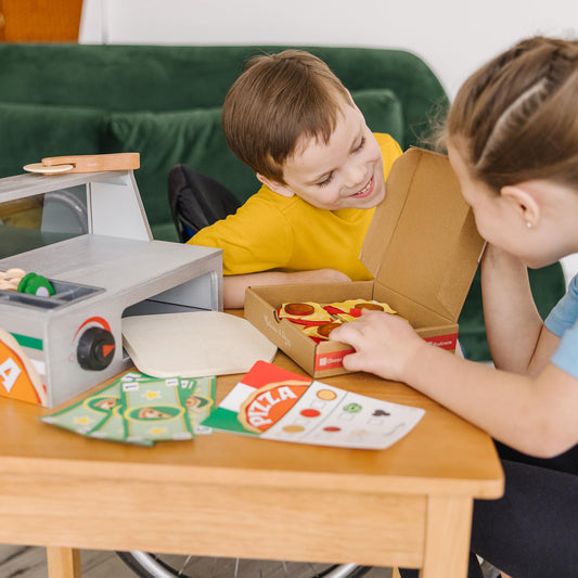 Wooden pizza crust sauce and cheese on Melissa & Doug set for hands-on pretend cooking