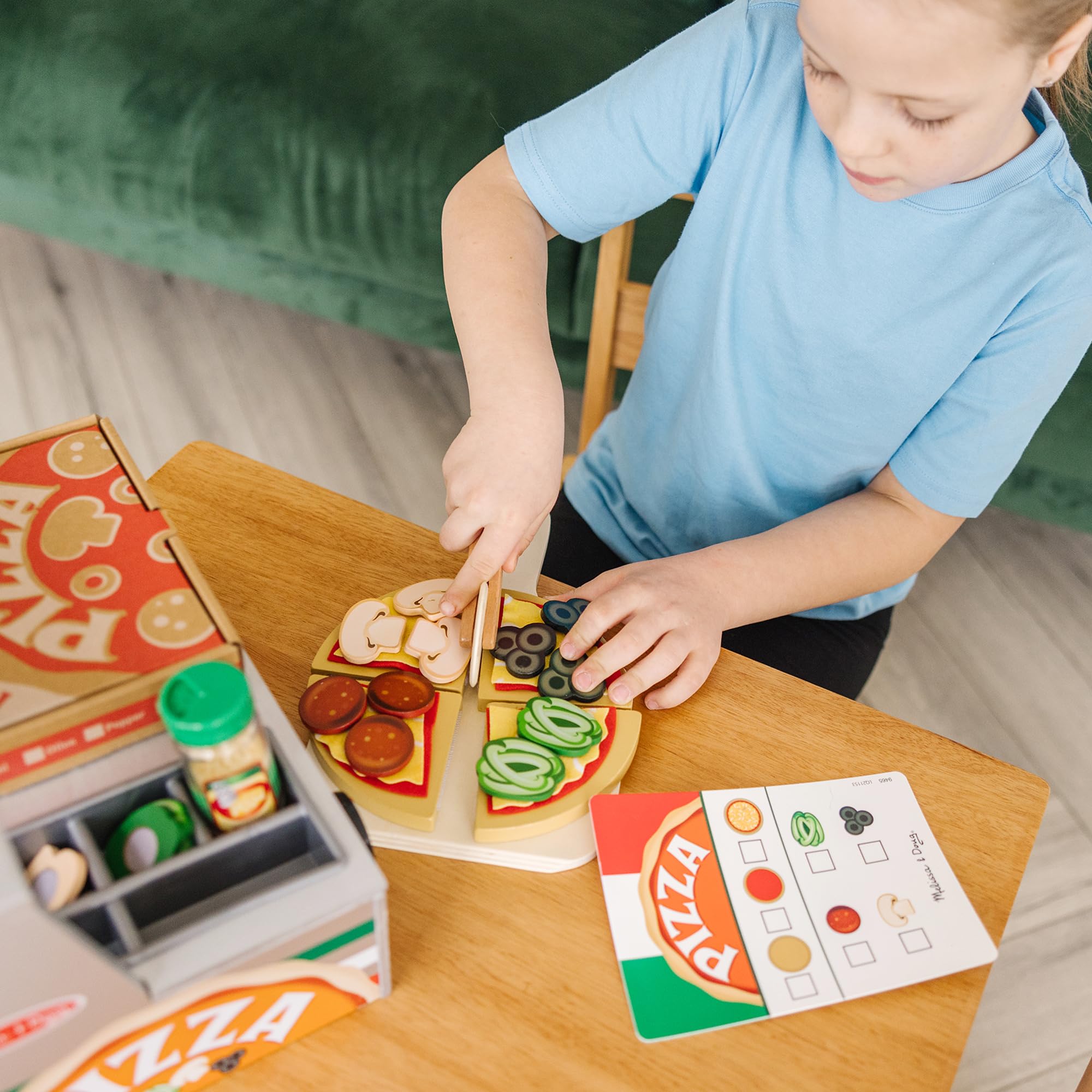 Toppings like pepperoni olives and mushrooms on Melissa & Doug wooden pizza pieces