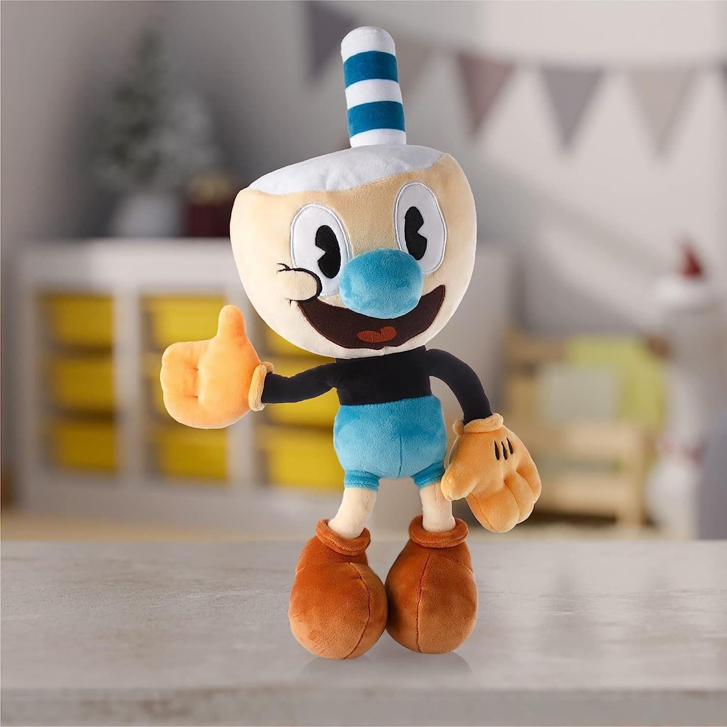 Mighty Mojo Cuphead Mugman plush held during travel or gameplay sessions.