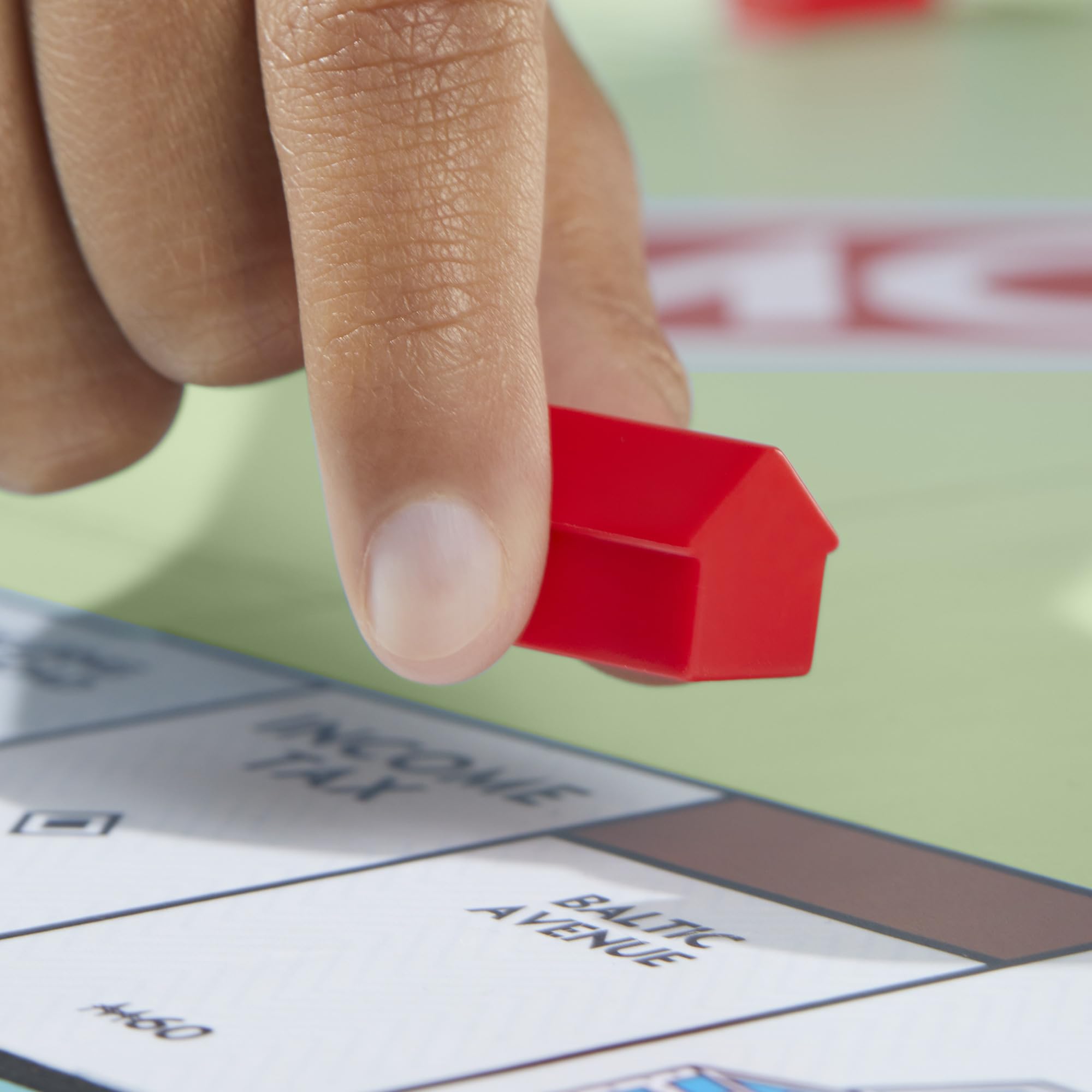 All Monopoly components laid out including cards, money, and tray for easy setup