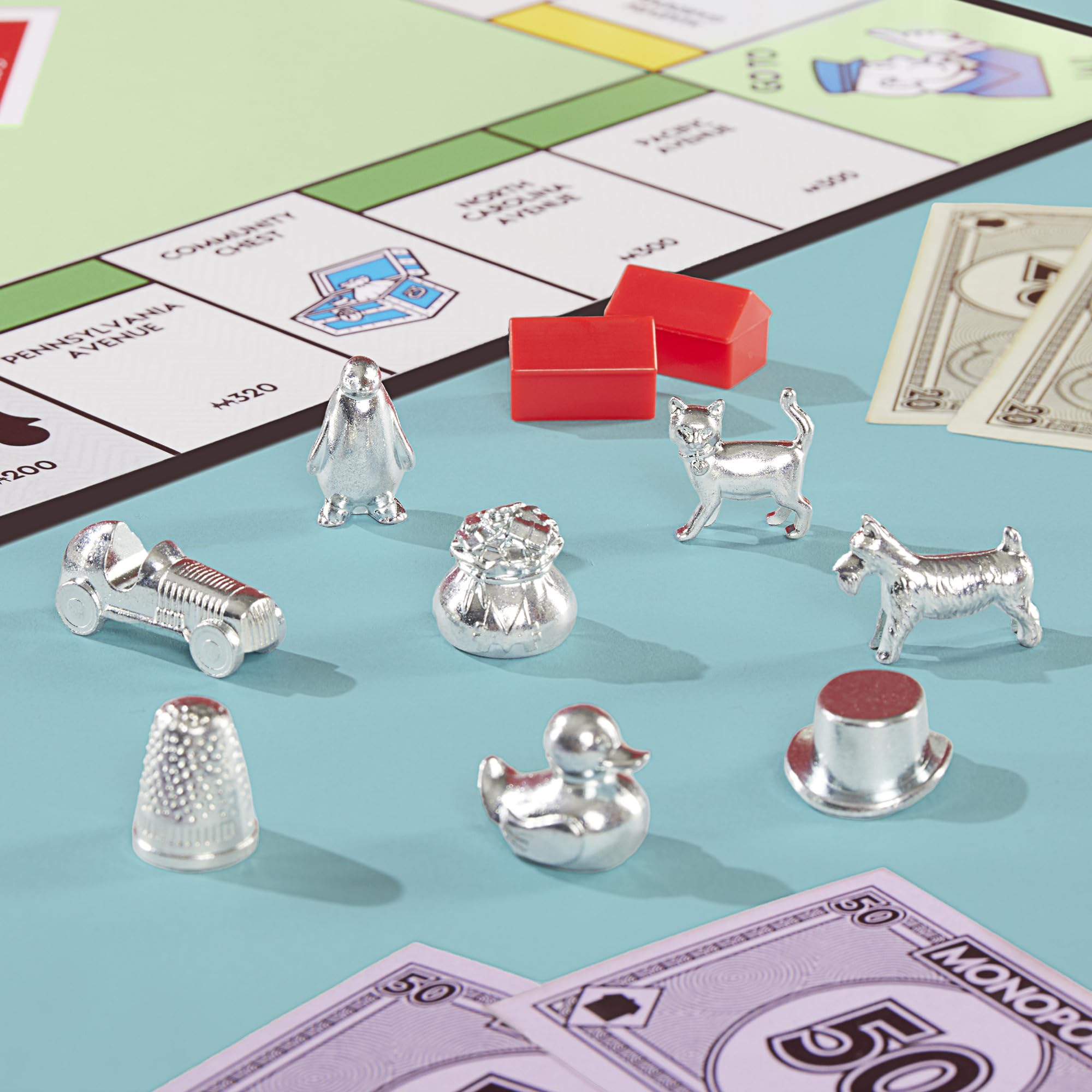 Close-up of eight larger metal tokens, Monopoly tokens offer better grip and visibility
