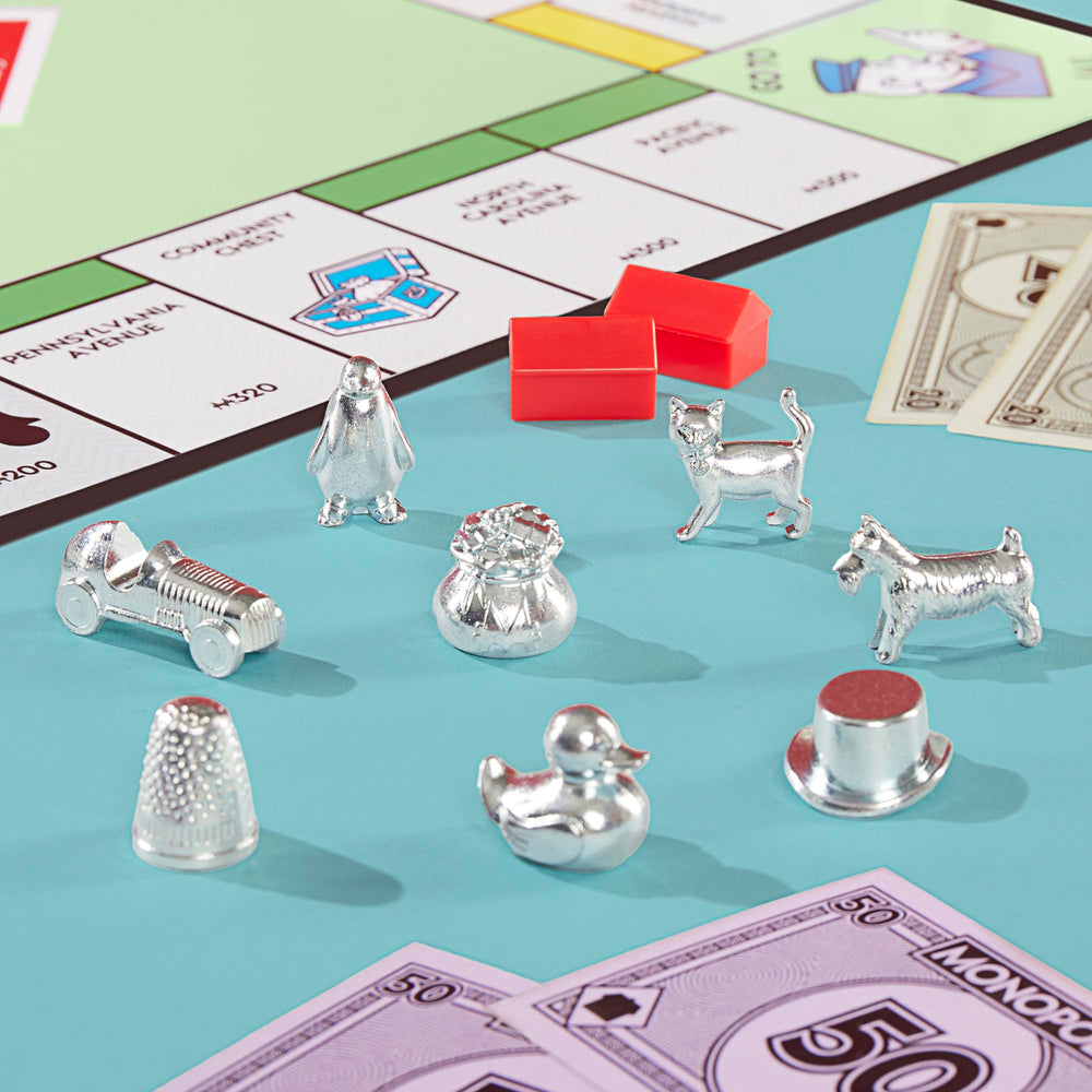 Close-up of eight larger metal tokens, Monopoly tokens offer better grip and visibility