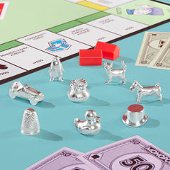 Close-up of eight larger metal tokens, Monopoly tokens offer better grip and visibility