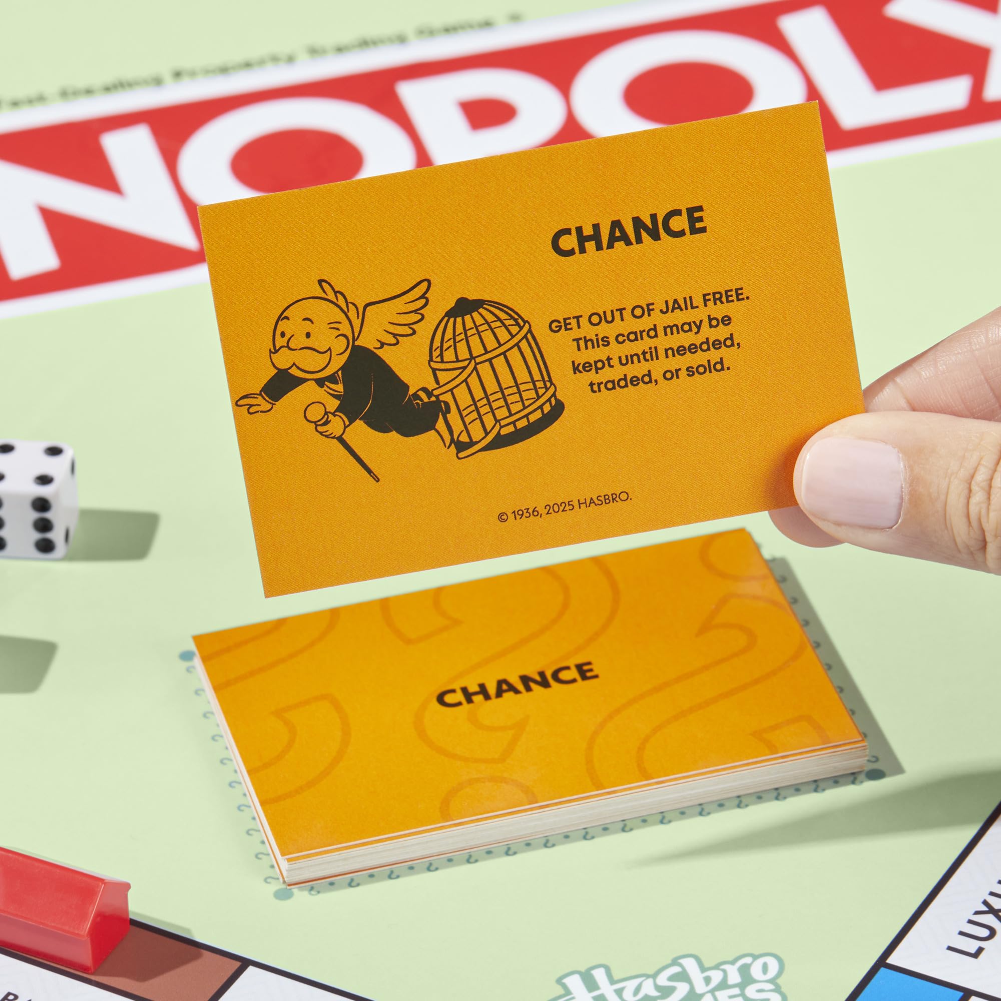 Players gathered around a table enjoying Monopoly, Monopoly brings family game nights together