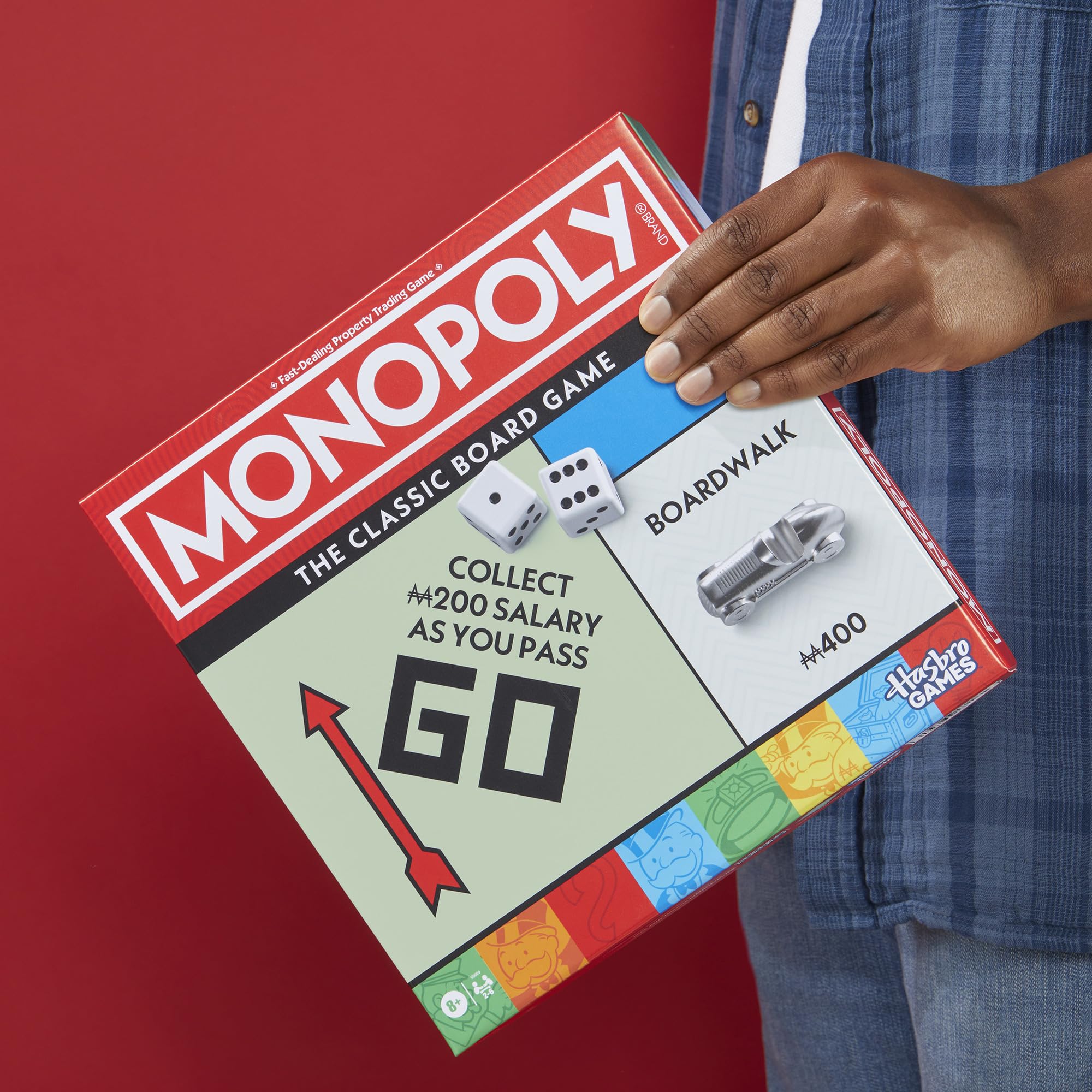 Hand holding a larger token to show scale, Monopoly tokens are easier for kids to handle