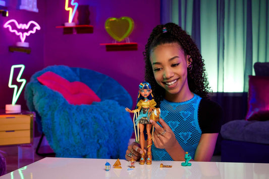 Monster High Hissette cobra pet beside the Cleo De Nile doll