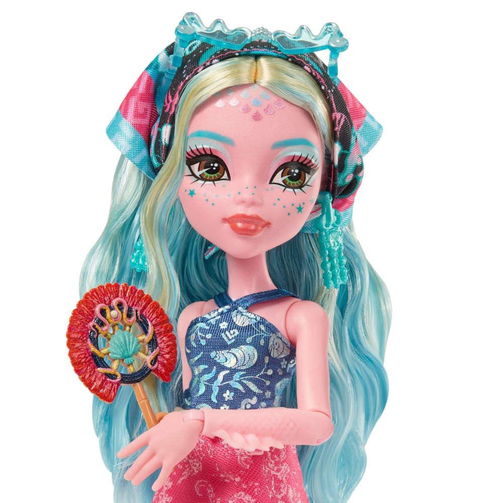 Monster High sea monster figure tucked inside luggage adds a mysterious coastal touch.