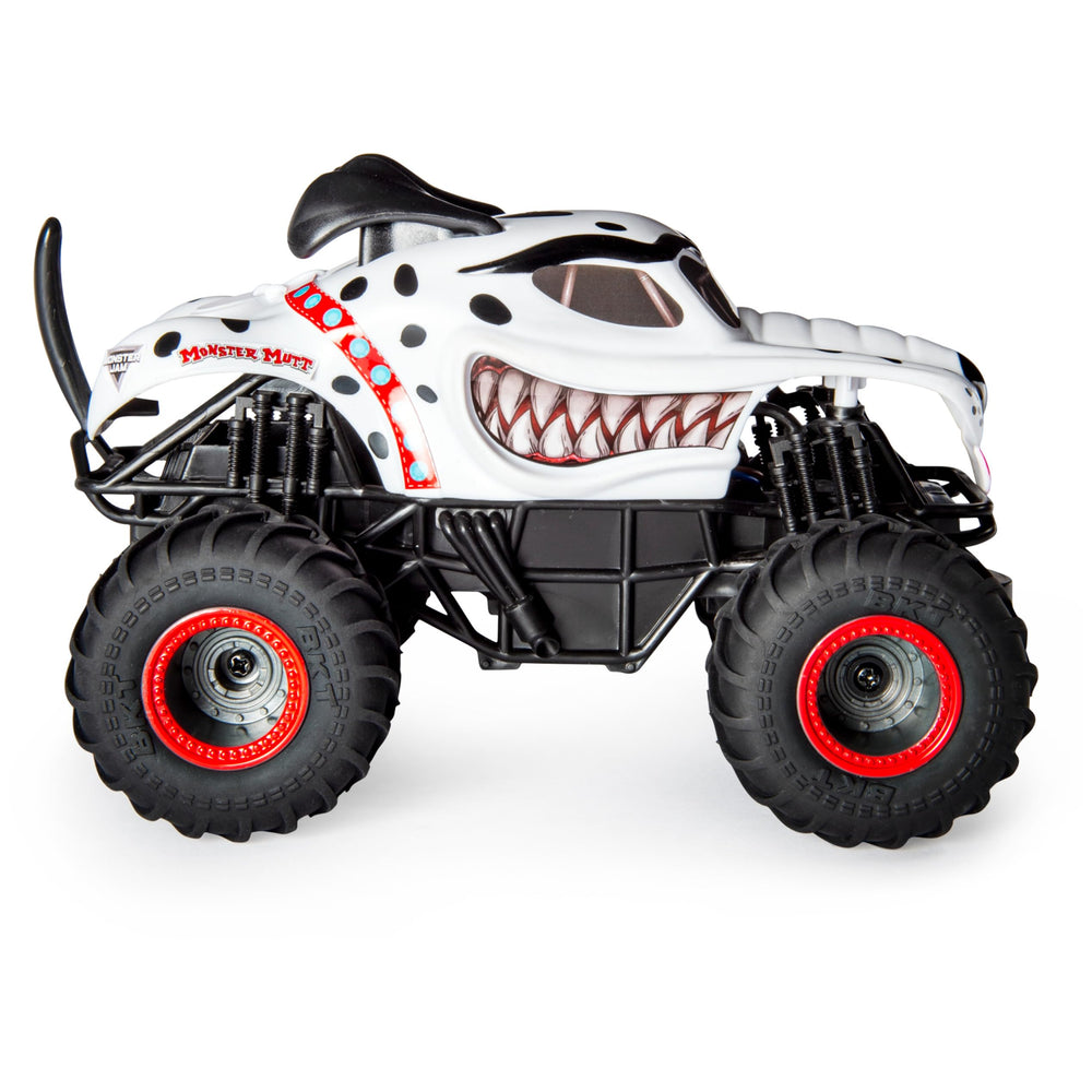 Monster Jam Monster Mutt Dalmatian RC truck in action performing donuts and big air.