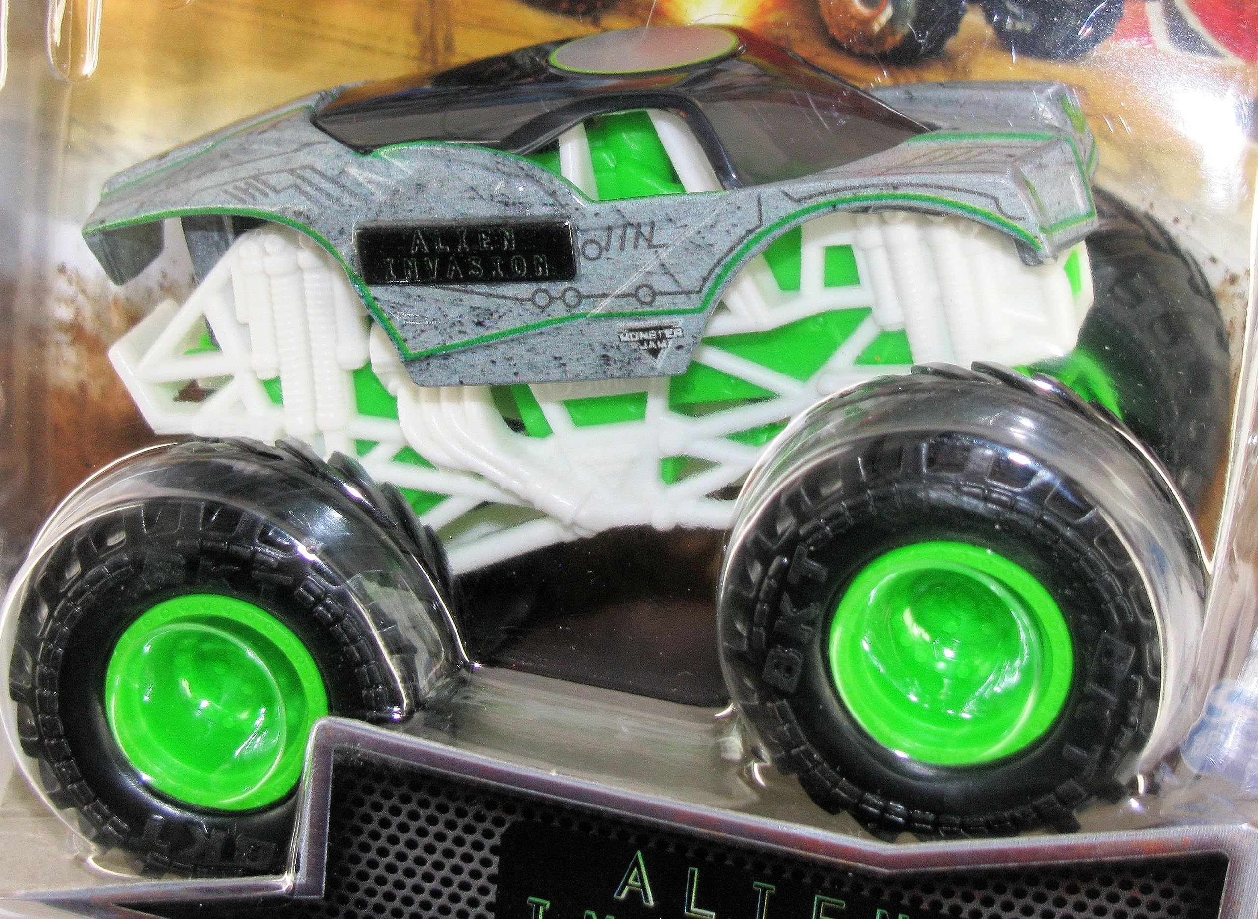 Monster Jam Steel Reveal Alien Invasion truck front view highlights bold graphics and tires.