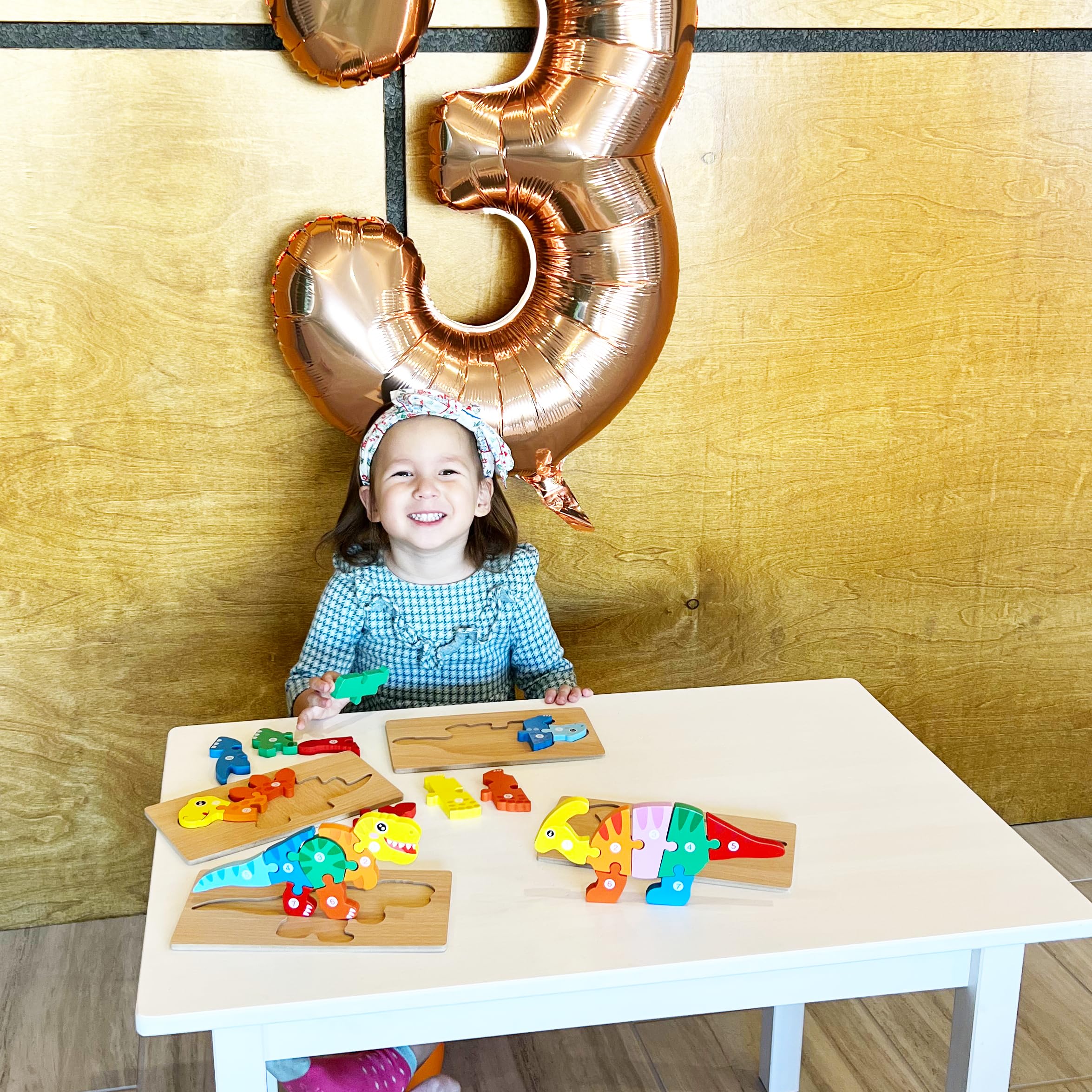 Montessori Mama dinosaur puzzles child playing demonstrates concentration during playtime.