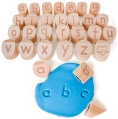 Montessori & Me Alphabet Stamps reveal lowercase letters for hands-on clay play and early recognition.